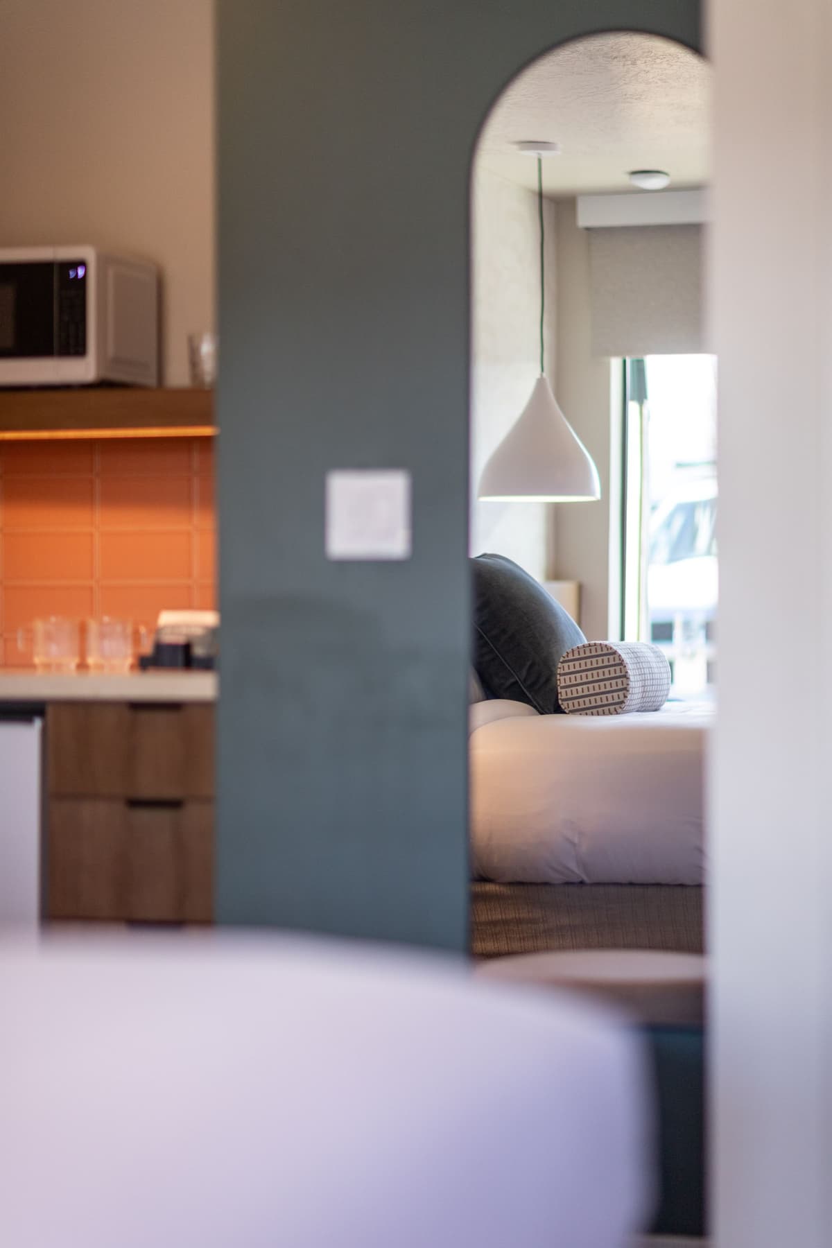 Soft interior detail with mirror and kitchenette at Adobe Desert Motel
